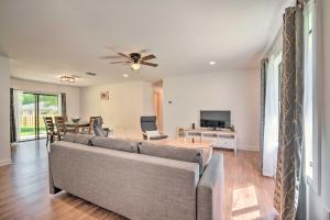 a living room with a couch and a tv at Cozy Retreat, 7 Mi to World Equestrian Center in Ocala