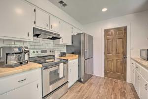 a kitchen with white appliances and a wooden floor at Cozy Retreat, 7 Mi to World Equestrian Center in Ocala