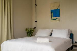 a bedroom with a bed with white sheets at Moro Inn in Korčula