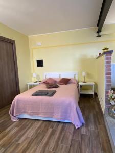 1 dormitorio con 1 cama con manta rosa en Atene del Canavese, en San Giorgio Canavese