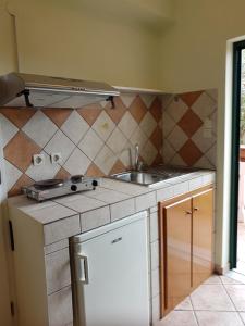 a kitchen with a sink and a counter top at Villasabella in Laganas