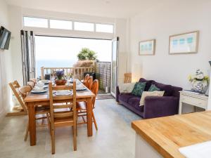 a kitchen and living room with a table and a couch at Seaview House in Ventnor