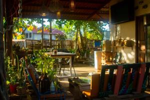 a patio with a table and chairs and plants at Las Porrocas Backpacer's in Pedasí Town