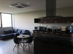 a living room with a couch and a table at Buyan Departamentos in Mérida