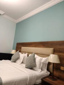 a bedroom with a bed with white sheets and pillows at منتجع فيوري - الهدا in Taif