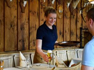 Eine Frau, die an einem Tisch in einem Restaurant steht. in der Unterkunft Gasthaus Jägerhaus in Fridingen an der Donau