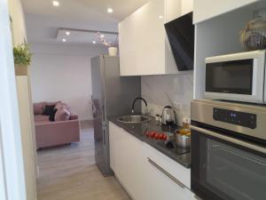 Kuchyň nebo kuchyňský kout v ubytování Apartments San Paulo