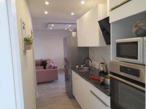 Kuchyň nebo kuchyňský kout v ubytování Apartments San Paulo