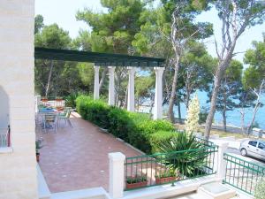 a pavilion with tables and chairs on a patio at Apartments Villa La Riva - Seafront accommodation in Sutivan +27 photos