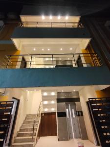 a view of a building with stairs and a door at Srirengavilasam Elite - Srirangam in Tiruchchirāppalli