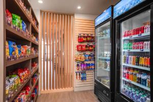 a grocery store aisle with a refrigerator and drinks at Holiday Inn Express & Suites Sanford - Lake Mary by IHG in Sanford +43 photos