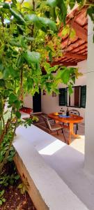 a patio with a wooden table in a house at Pansion Ivan & Ivana in Bol