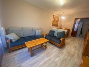 a living room with a couch and a coffee table at APARTAMENTO TURIETO (BROTO-ORDESA) in Broto