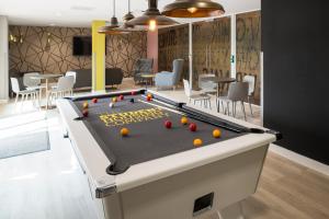 a pool table with balls on it in a room at Yugo Explore - Arofan House in Cardiff