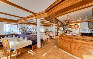 a woman standing at a counter in a restaurant at Hotel Restaurant Waldhorn Holzgerlingen in Holzgerlingen