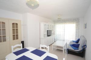 a bedroom with a bed and a chair and a tv at PLAYASOL Orangecosta 1 dormitorio in Benicàssim