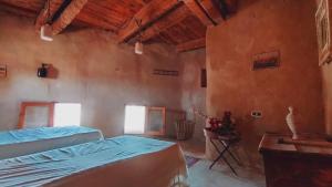 A bed or beds in a room at NaInshal Siwa