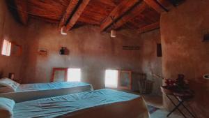A bed or beds in a room at NaInshal Siwa