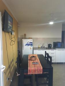 a kitchen with a table and a refrigerator at Liquidambar in Federación +3 photos