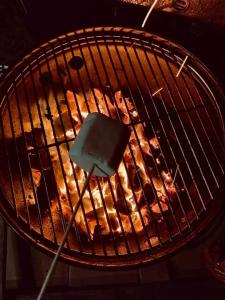 a grill with a spatula cooking food on it at Skipbridge farm glamping in York