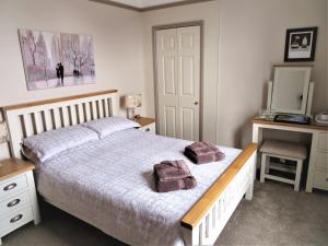 a bedroom with a bed with two towels on it at Whitehaven Guest House in Whitby