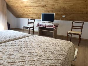 Кровать или кровати в номере Pensiune Agroturistica La Nasu