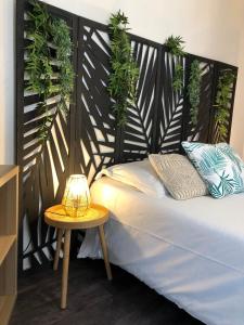 a bedroom with a bed and a table with a lamp at Equateur-centre Jaude in Clermont-Ferrand