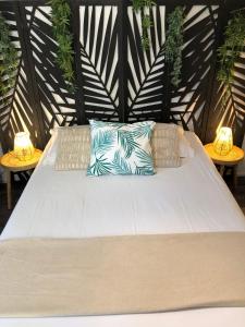 a large white bed with pillows on a patio at Equateur-centre Jaude in Clermont-Ferrand