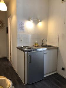 a small kitchen with a sink and a stove at Equateur-centre Jaude in Clermont-Ferrand