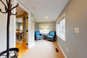 a living room with blue chairs and a table at The 302 Retreat in Bartlett