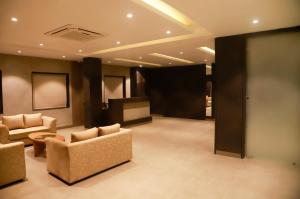 a lobby with two chairs and a projection screen at VIORAY INN in Deoghar