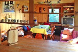 a living room with a table and a tv at Holiday Home Kaltennordheim - DMG07039-F in Kaltennordheim