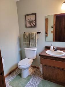 a bathroom with a white toilet and a sink at Cavalier # 2 townhouse in Cable