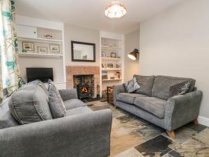 a living room with two couches and a fireplace at No 2 Waterloo Street in Cockermouth