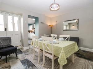 a dining room with a table and chairs and a mirror at No 2 Waterloo Street in Cockermouth