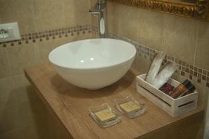 a bathroom with a white bowl sink on a wooden counter at Ca Del Sole Venice in Venice
