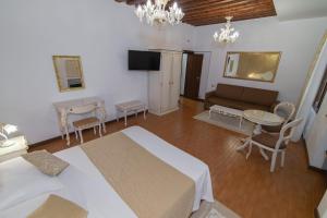 a living room with two beds and a couch and a table at Ca Del Sole Venice in Venice
