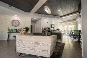 a lobby with a clock on the wall and chairs at Twin Mountain Inn & Suites in Pigeon Forge