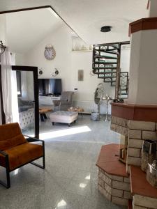 a living room with a chair and a fireplace at Luxeriöse Villa mit Bergblick in Donji Ljenobud