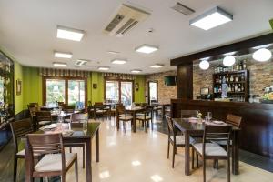 a restaurant with tables and chairs and a bar at Hotel Rural Campaniola in Pontevedra