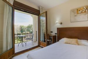 a bedroom with a bed and a view of a balcony at Hotel Rural Campaniola in Pontevedra +31 photos