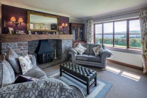 a living room with a couch and a fireplace at Beaconsview B&B in Brecon