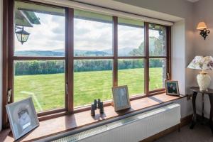a window with a view of a green field at Beaconsview B&B in Brecon +13 photos