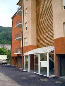a building with awning in front of a building at Superbe appart avec de parking gratuit sur place in Lourdes +5 photos