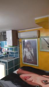 a kitchen with a picture of a man on the wall at Airport Jackson Loft in Catania