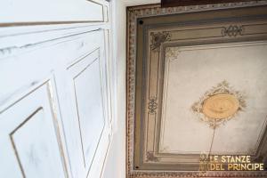 a framed picture on a wall next to a door at Le Stanze del Principe in Naples