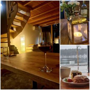 un verre de vin et une assiette de nourriture sur une table dans l'établissement Zacisze Mazurskie, à Ryn 111 autres photos