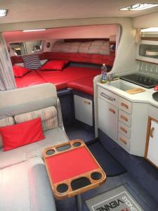 an interior of an rv with a couch and a sink at Location Bateau Hôtel Antibes in Antibes
