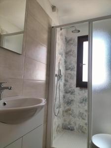 a bathroom with a sink and a shower stall at Gabri's Home in Spello