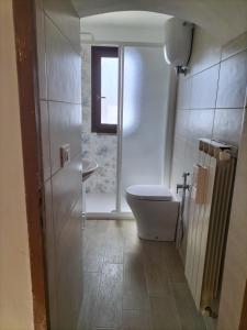 a bathroom with a toilet and a window at Gabri's Home in Spello +47 photos